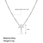 Silver necklace with cross pendant on a white background, showing measurements and material details.