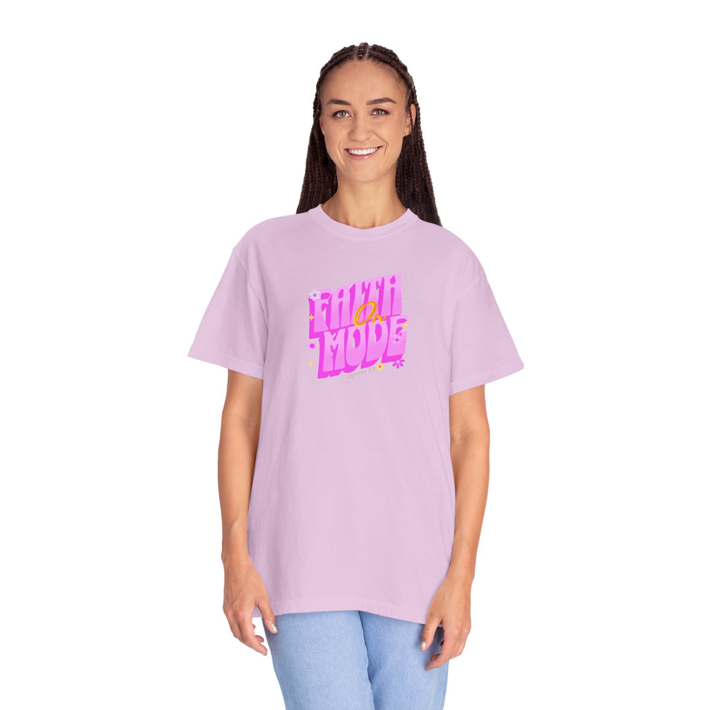Person wearing a light purple t-shirt with pink text on a white background