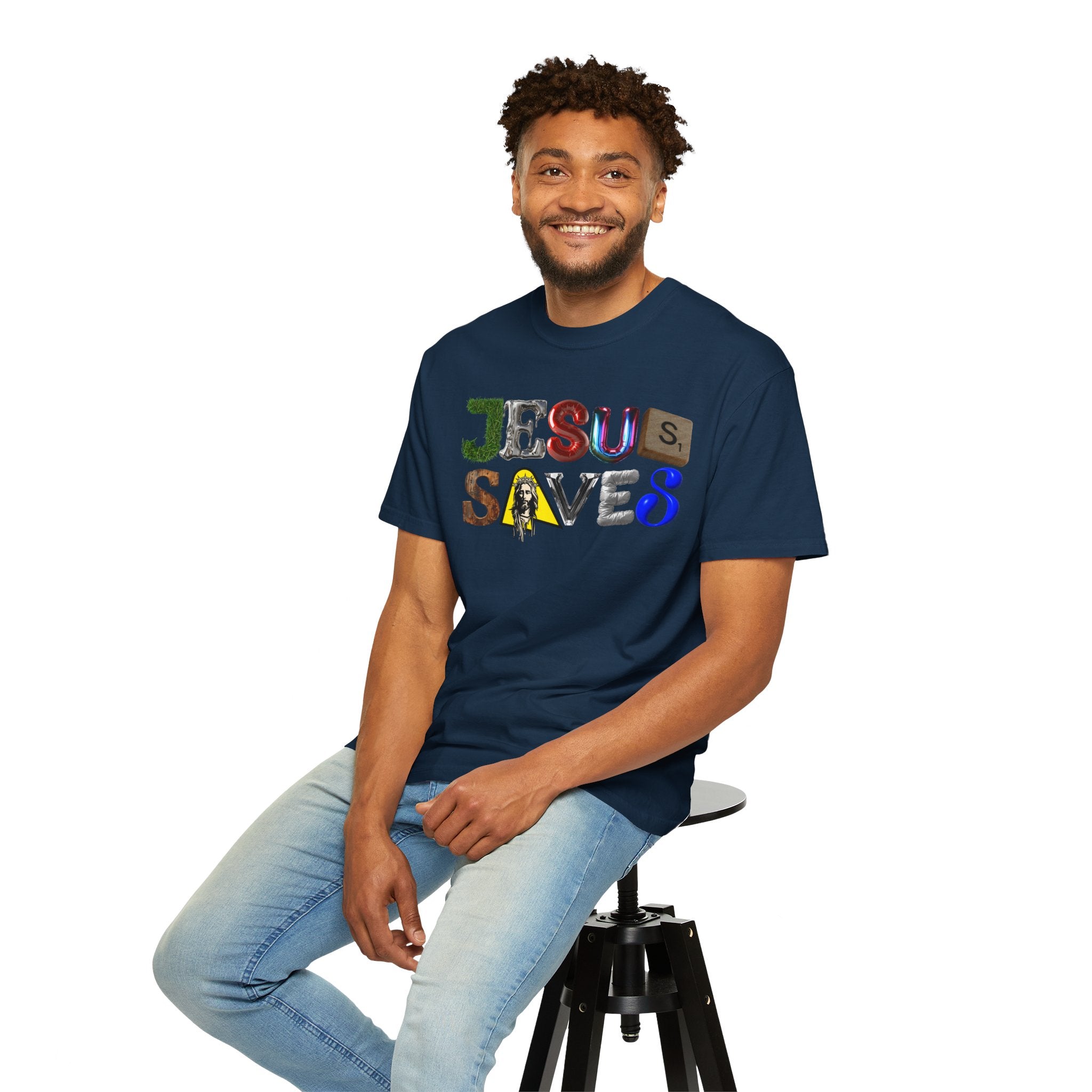Man wearing a navy blue t-shirt with 'Jesus Saves' text, sitting on a stool against a white background