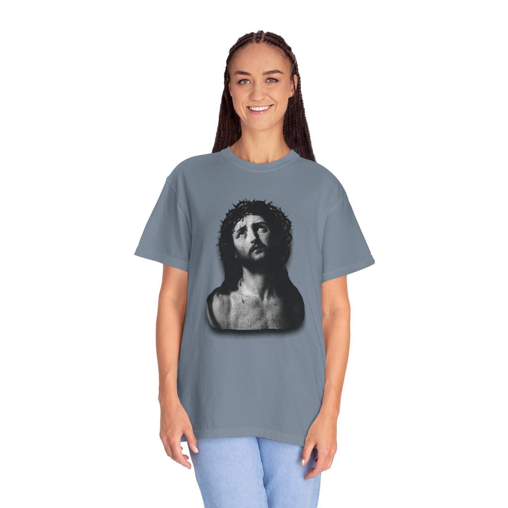 Person wearing a gray t-shirt with a graphic design on a white background
