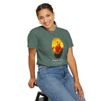 Person wearing a green t-shirt with a graphic design on a white background