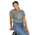 Person wearing a gray t-shirt with 'God is Good' text and a heart symbol on a white background