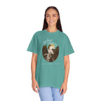 Person wearing a teal t-shirt with a graphic design and text on a white background