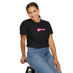 Person wearing a black t-shirt with pink text and blue jeans on a white background