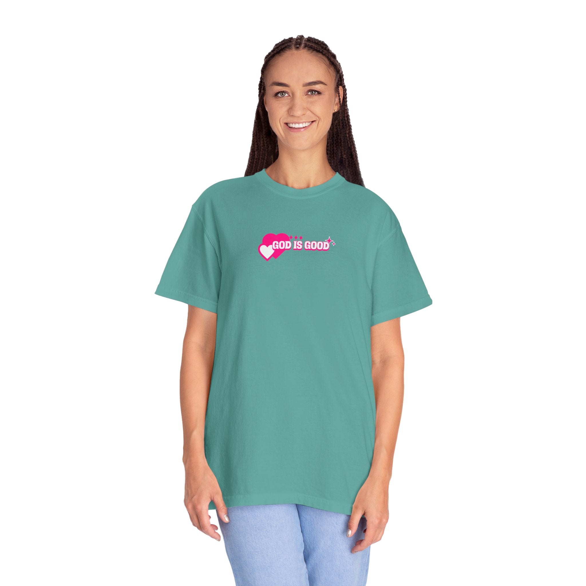 Woman wearing a teal t-shirt with 'God is Good' text on a white background