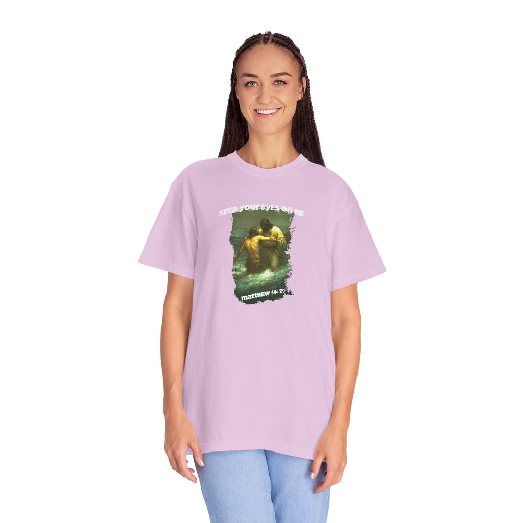 Person wearing a purple t-shirt with a graphic design on a white background