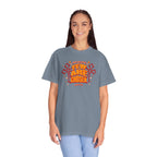 Person wearing a gray t-shirt with red and yellow text design on a white background