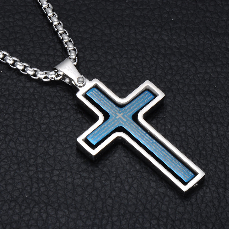 Cross-shaped pendant with blue inlay on a black textured background
