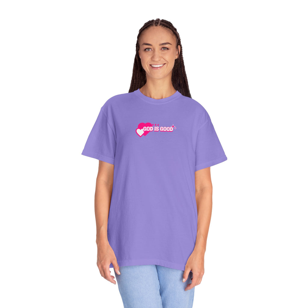 Woman wearing a purple t-shirt with 'God is Good' text on a white background