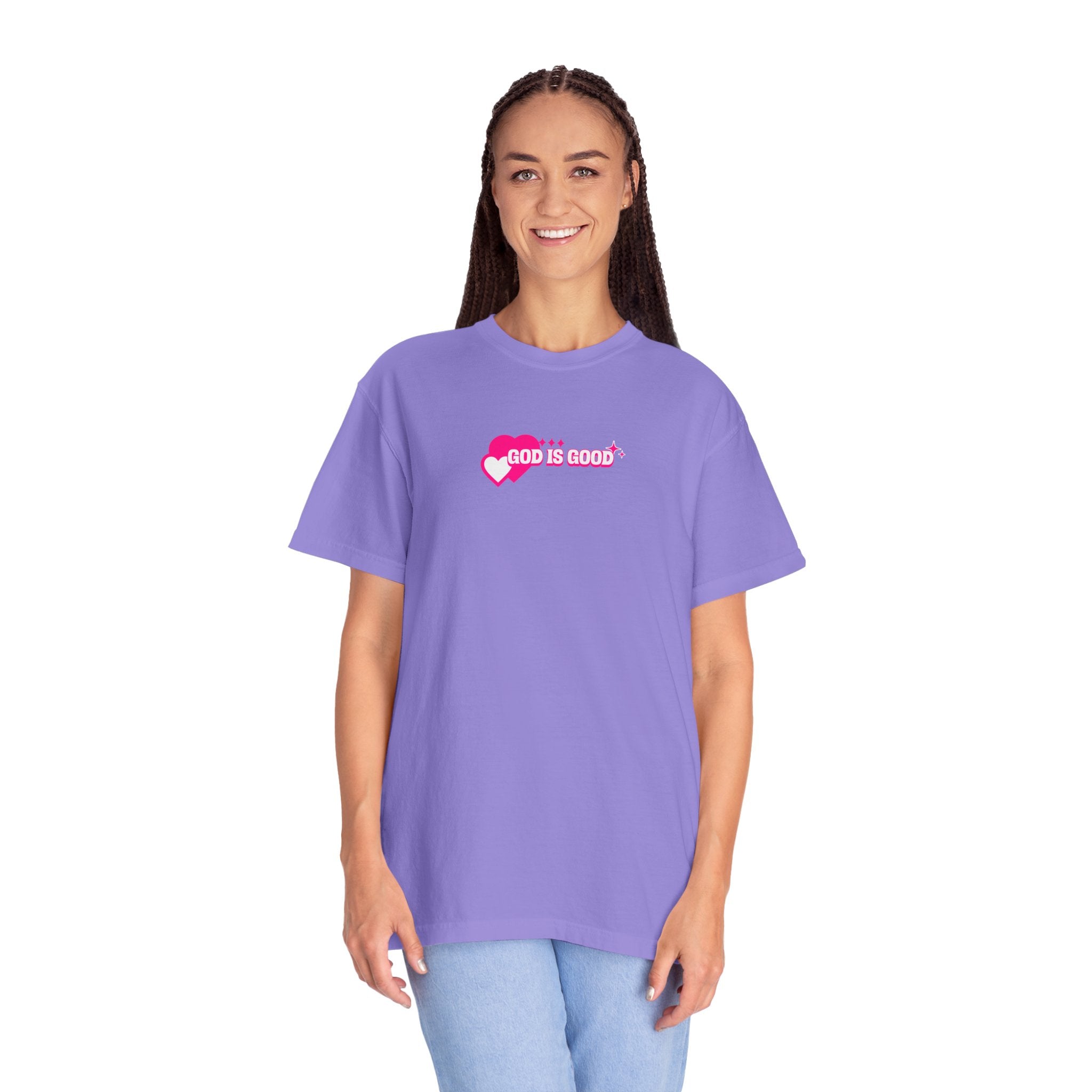 Woman wearing a purple t-shirt with 'God is Good' text on a white background