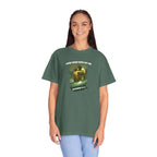Person wearing a green t-shirt with a graphic design and text on a white background