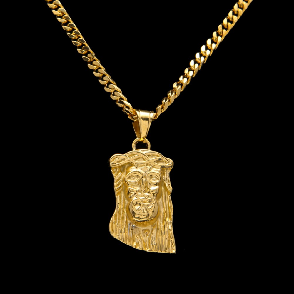 Gold necklace with a Jesus face pendant on a black background