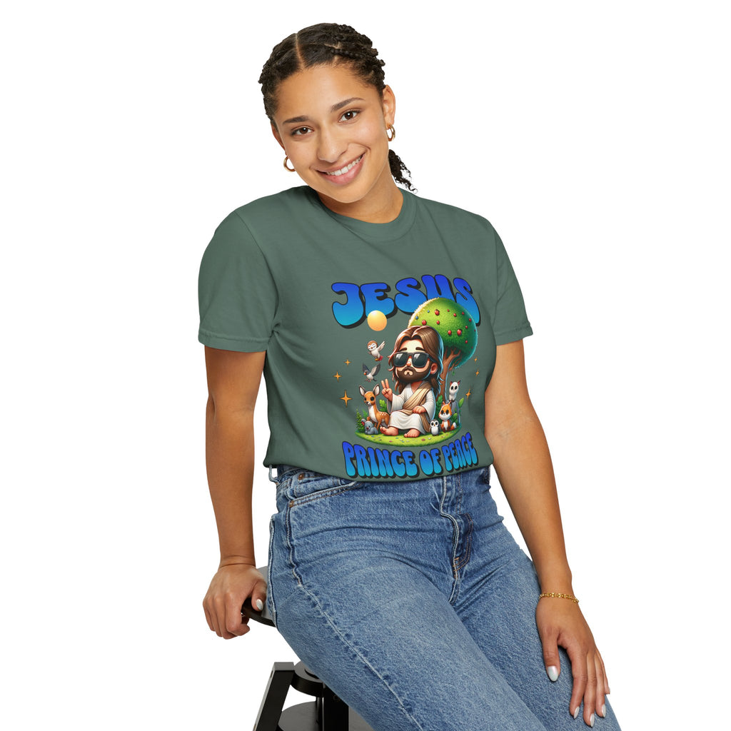 Person wearing a green t-shirt with a graphic design sitting on a stool against a white background