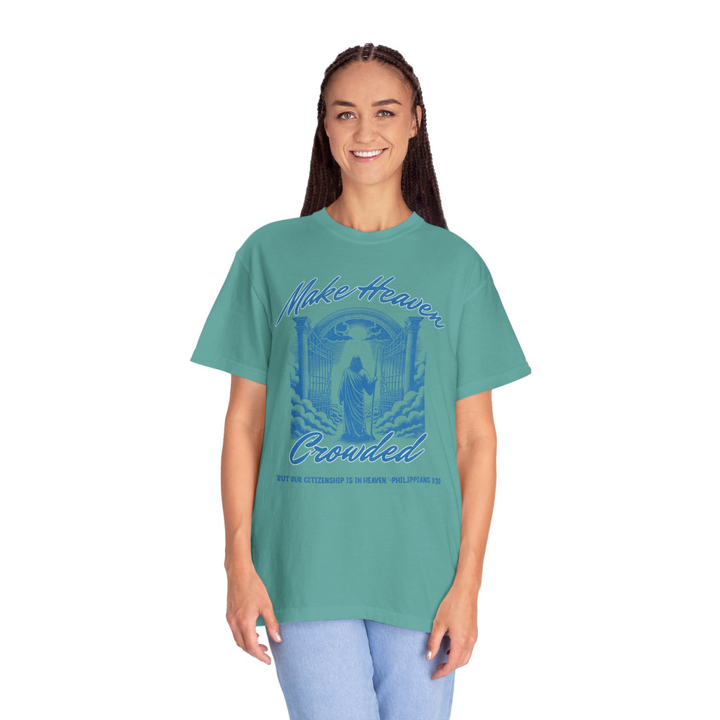 Person wearing a teal t-shirt with a graphic design and text on a white background