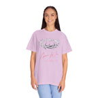 Person wearing a pink t-shirt with a design and text on a white background