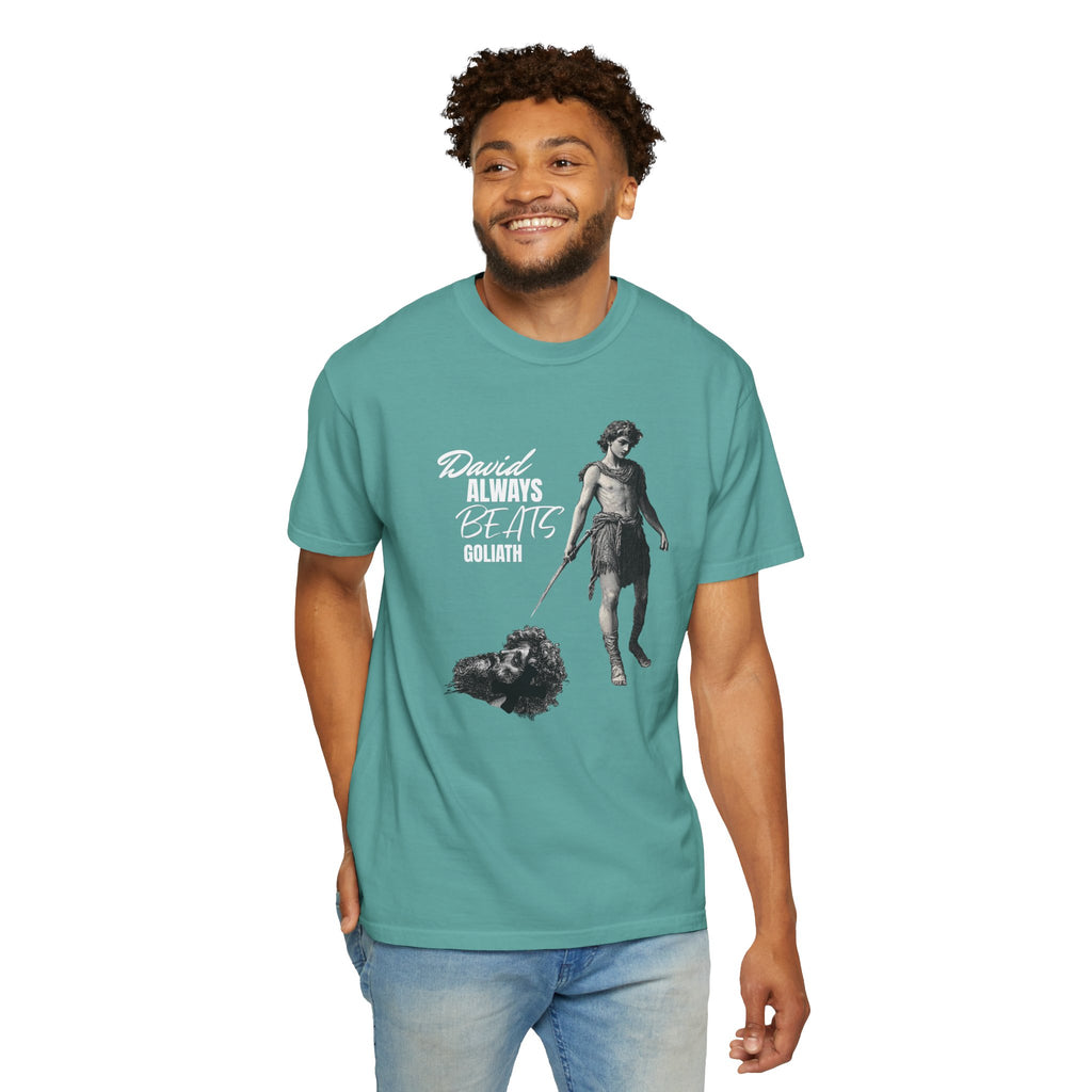 Man wearing a teal t-shirt with a graphic design and text on a white background