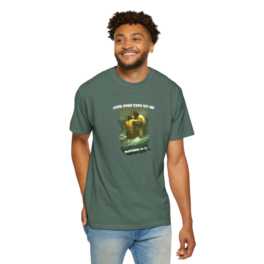 Man wearing a green t-shirt with a graphic design on a white background