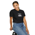 Person wearing a black t-shirt with a graphic design on a white background