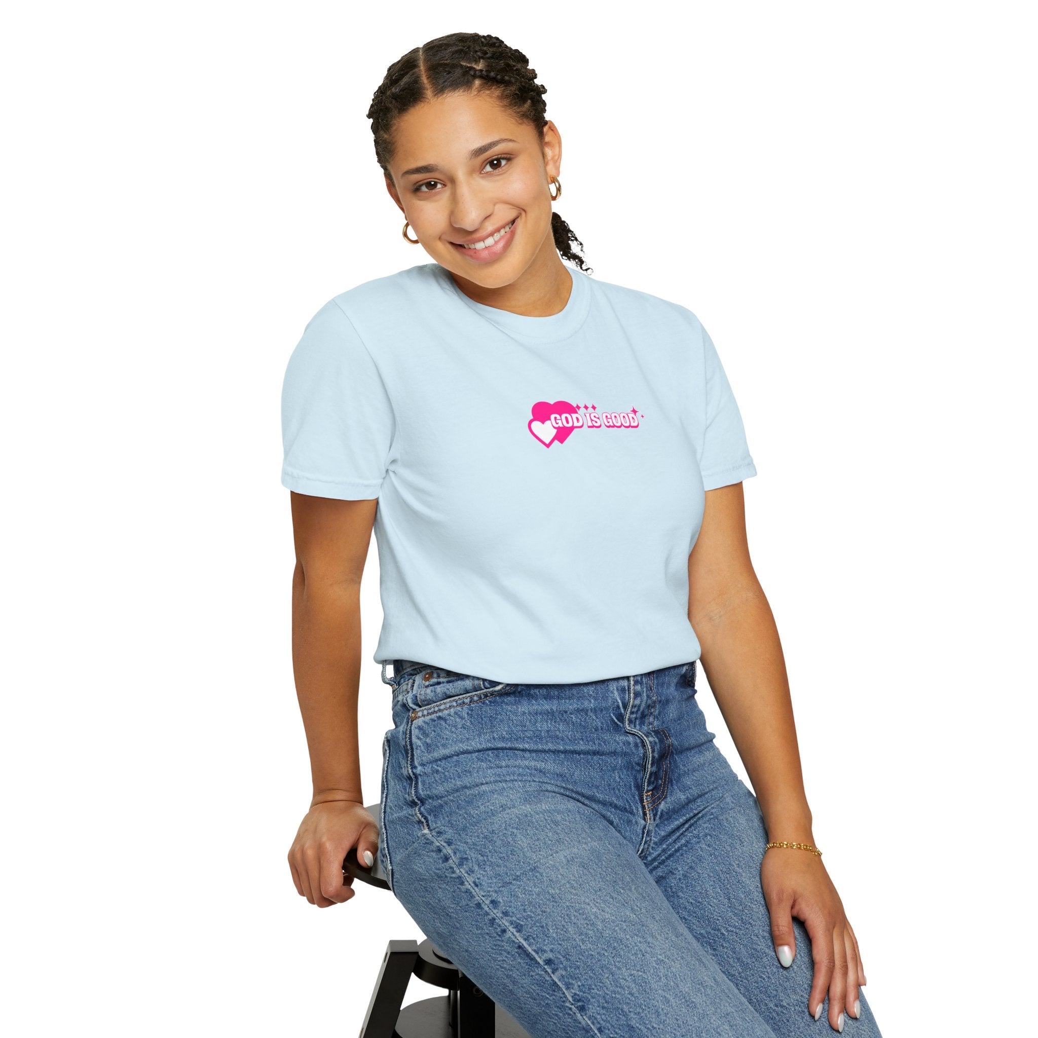 Person wearing a light blue t-shirt with a pink logo on a white background