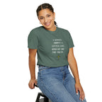 Person wearing a green t-shirt with text and sitting on a stool against a white background