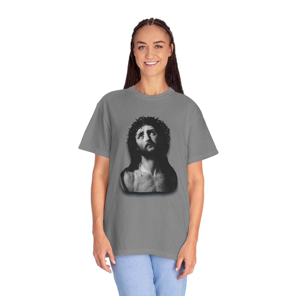 Person wearing a gray t-shirt with a graphic design on a white background