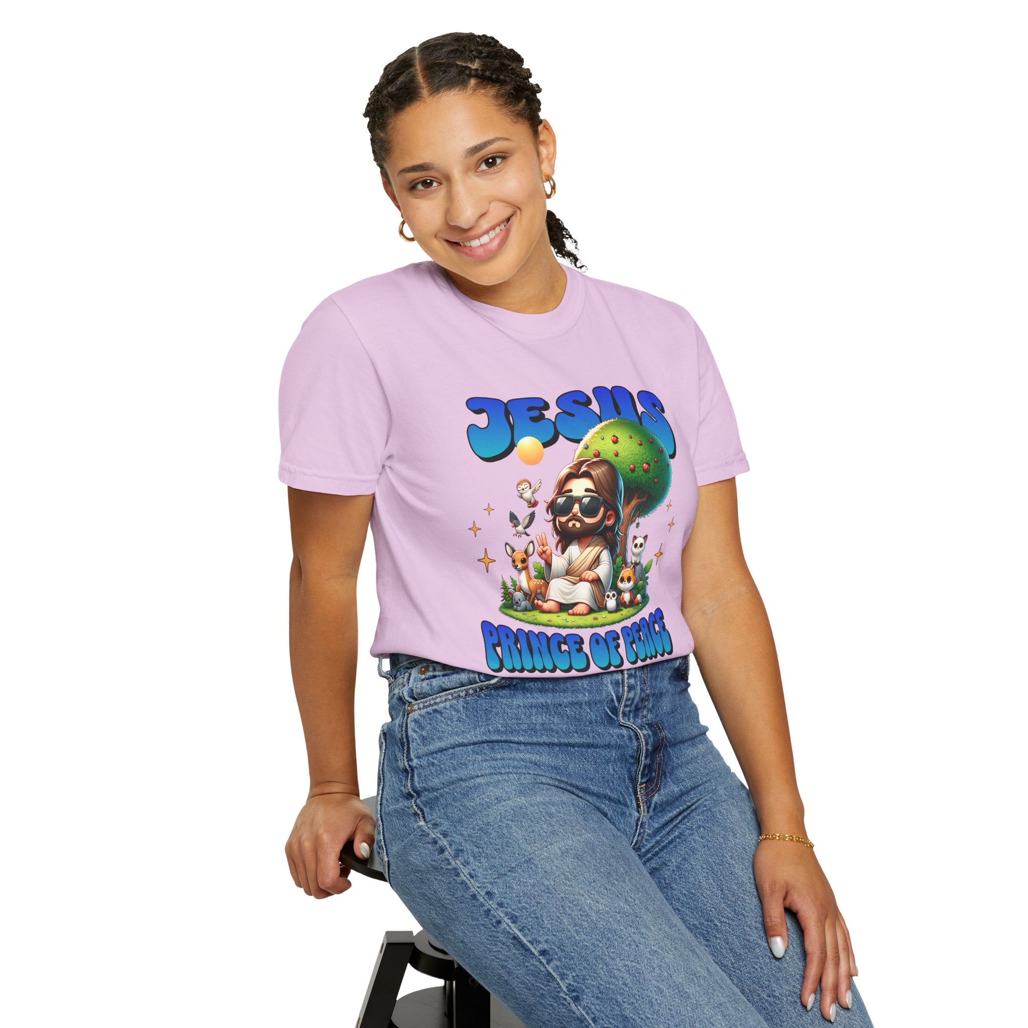 Person wearing a purple t-shirt with a graphic design sitting on a stool against a white background