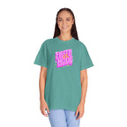 Person wearing a teal t-shirt with pink and white text on a white background