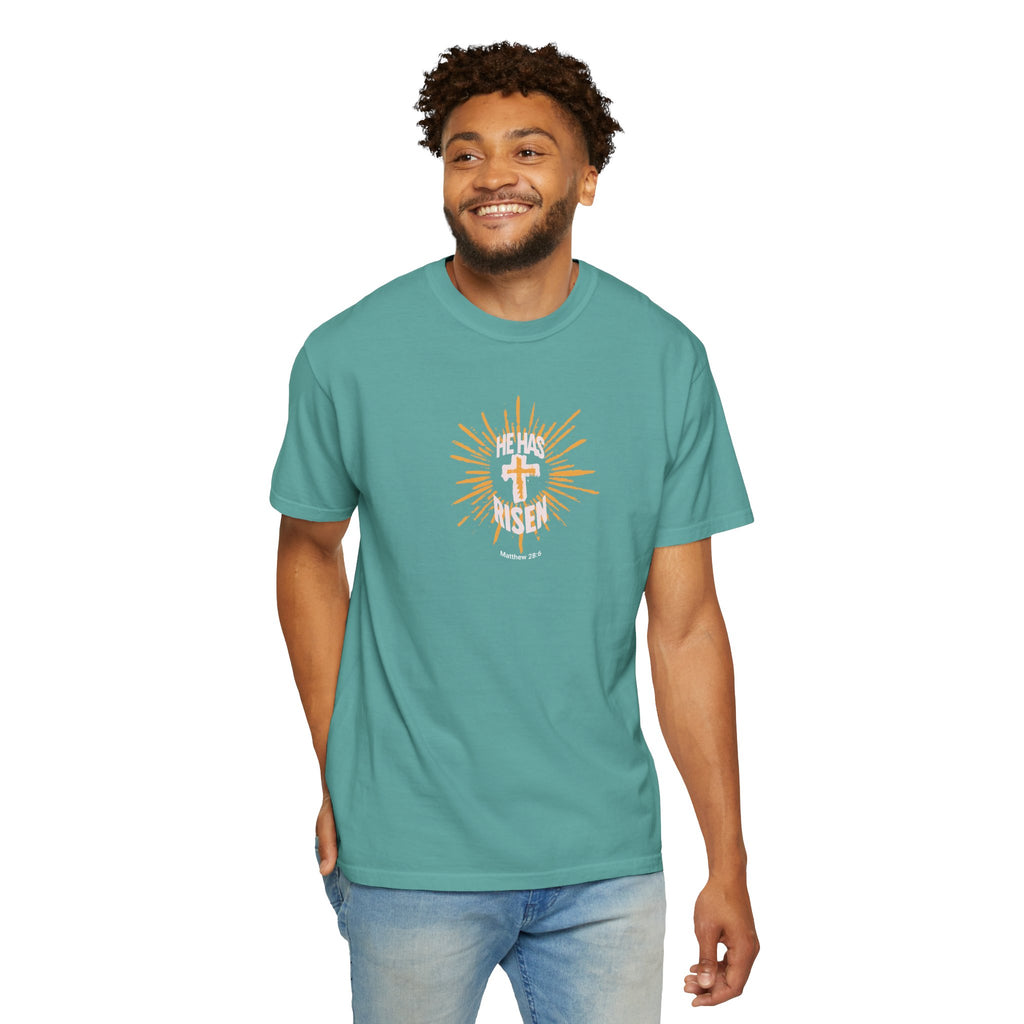 Man wearing a teal t-shirt with a graphic design on a white background