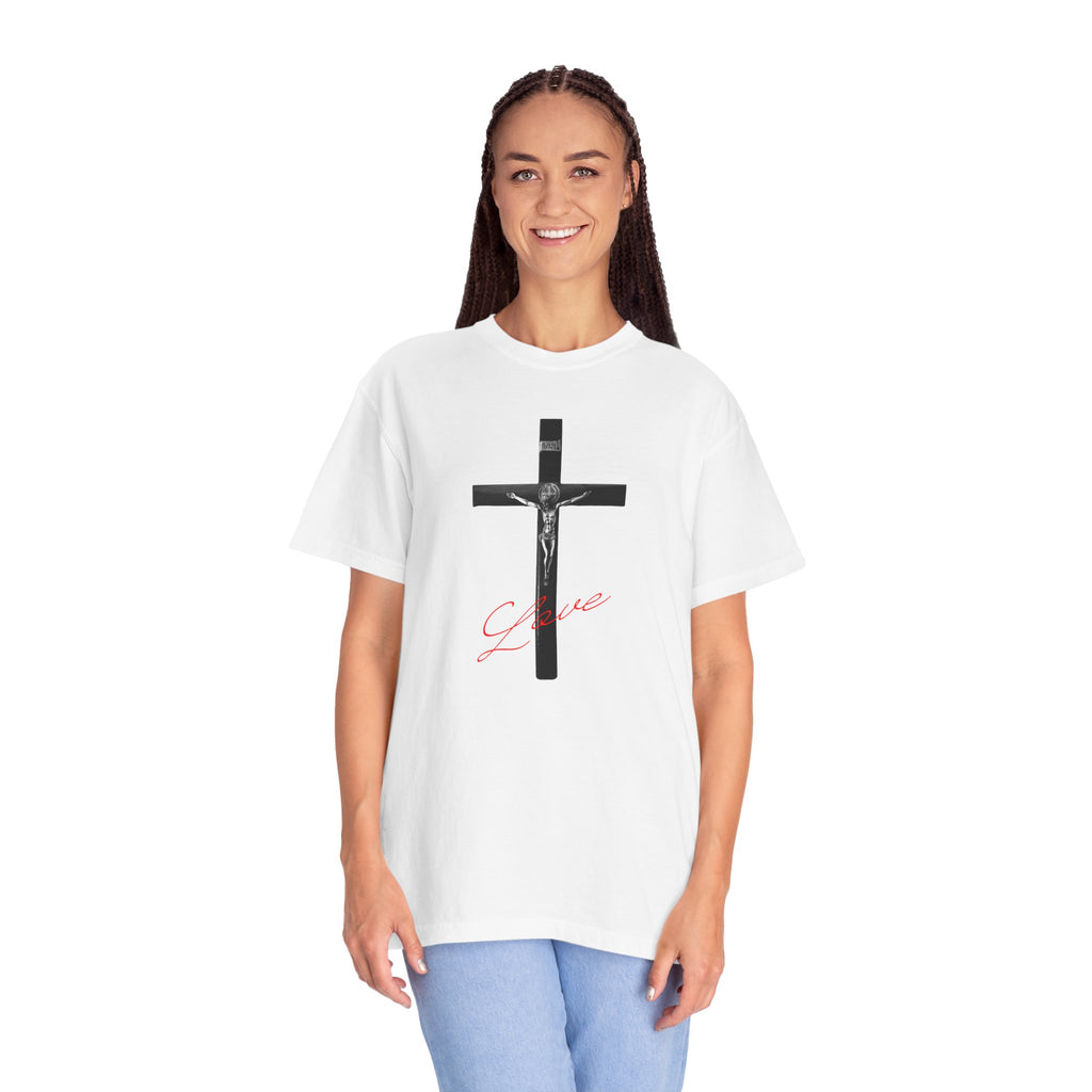Person wearing a white t-shirt with a black cross and red text on a white background