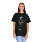 Person wearing a black t-shirt with a graphic design on a white background