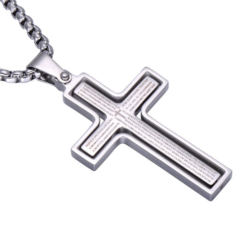 Silver cross pendant with engraved text on a white background