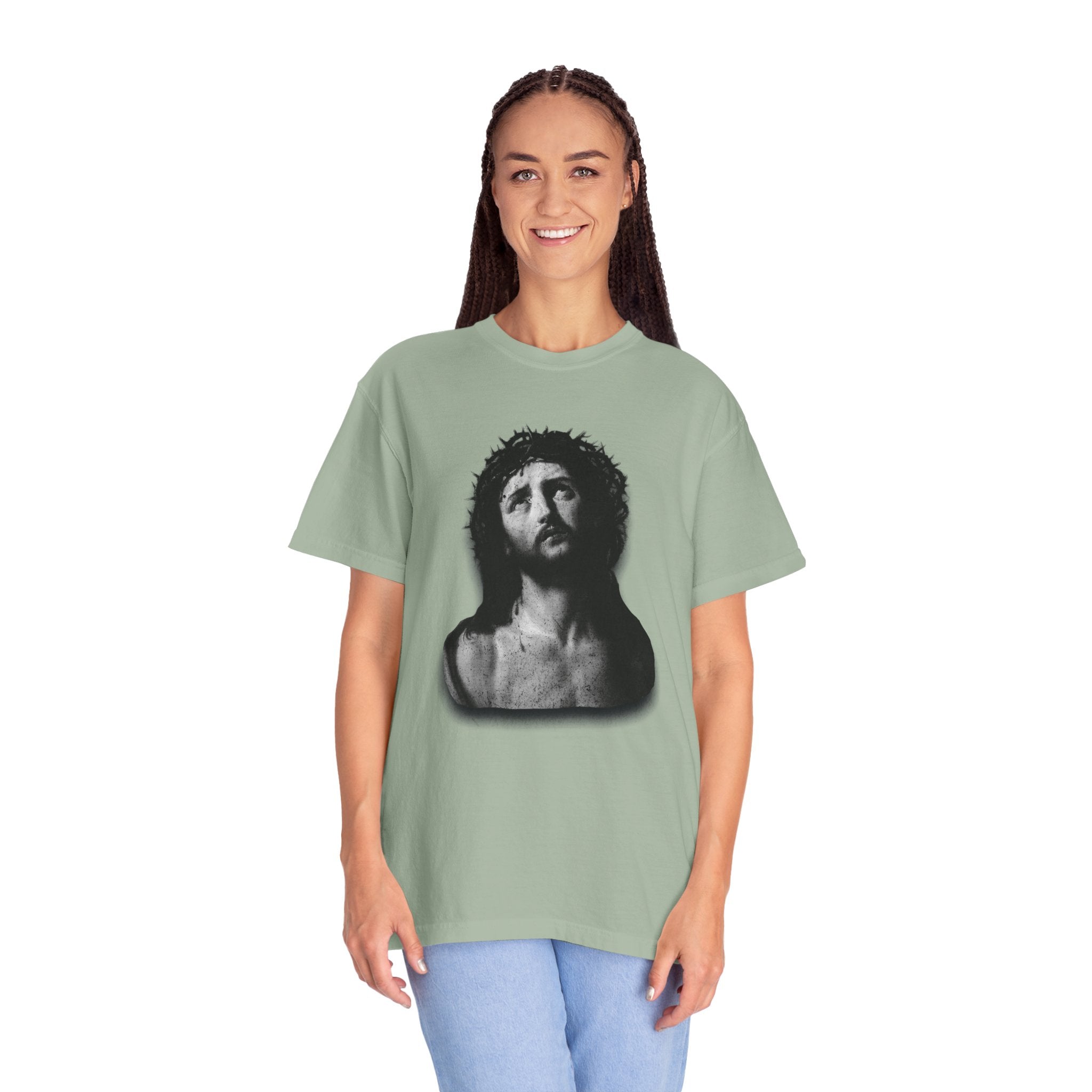 Person wearing a green t-shirt with a graphic design on a white background
