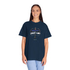Person wearing a navy blue t-shirt with a graphic design on a white background