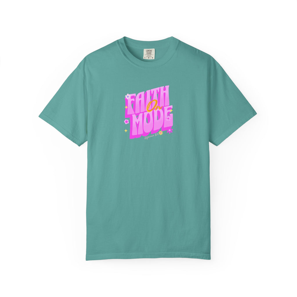 Teal t-shirt with pink and white text on a white background