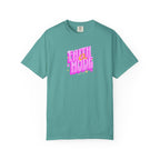 Teal t-shirt with pink and white text on a white background
