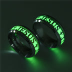 Two black rings with 'Jesus' text on a dark background