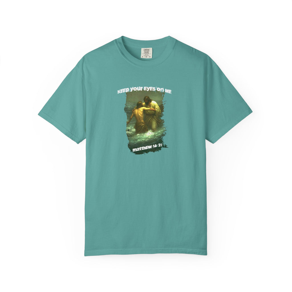 Teal t-shirt with graphic design and text on a white background