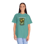 Person wearing a teal t-shirt with a graphic design and text on a white background