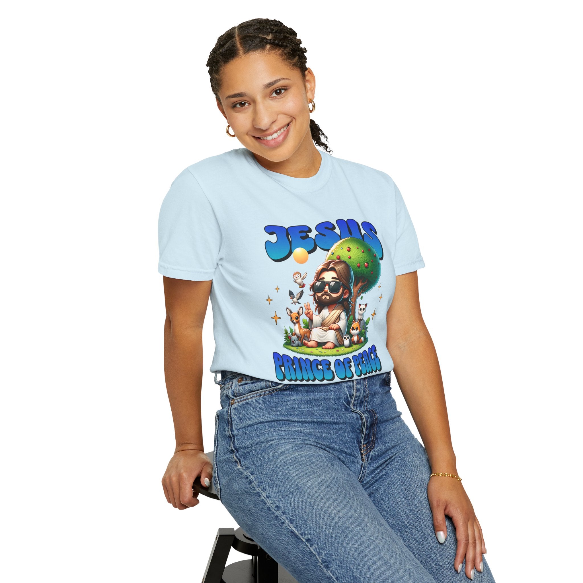 Person wearing a light blue t-shirt with a colorful graphic design on a white background