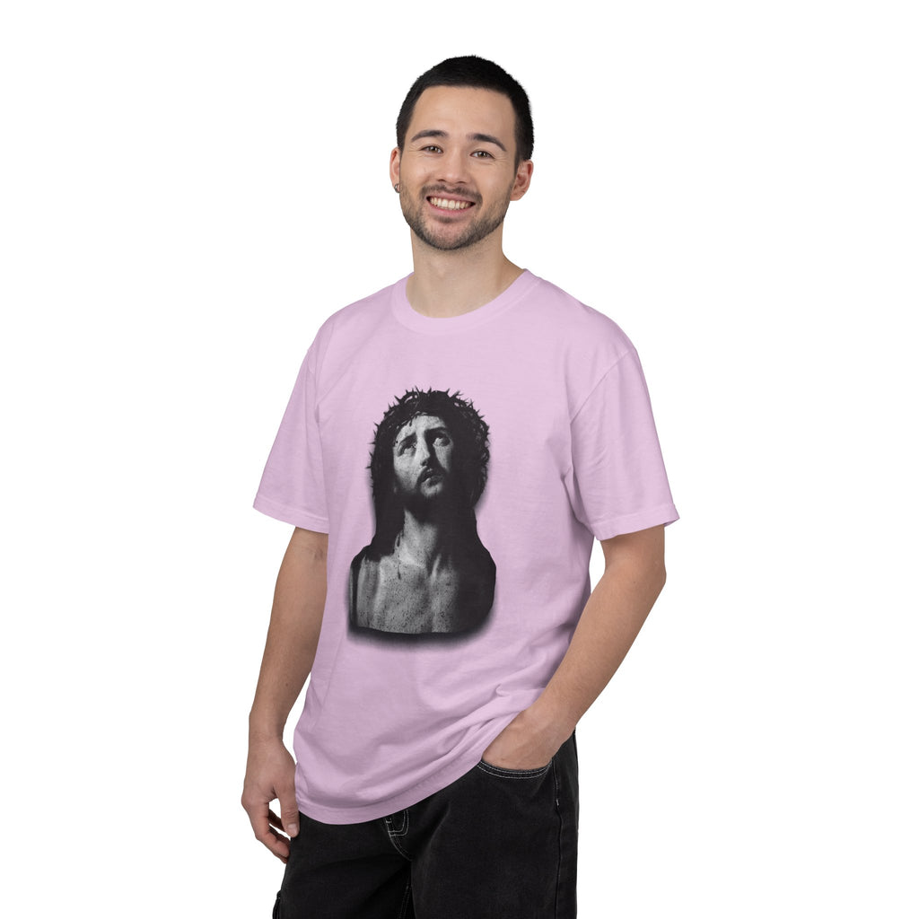 Person wearing a pink t-shirt with a graphic design on a white background