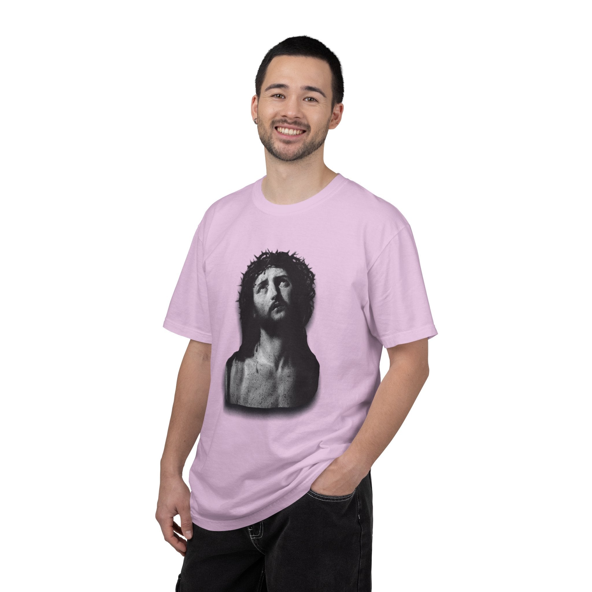Person wearing a pink t-shirt with a graphic design on a white background
