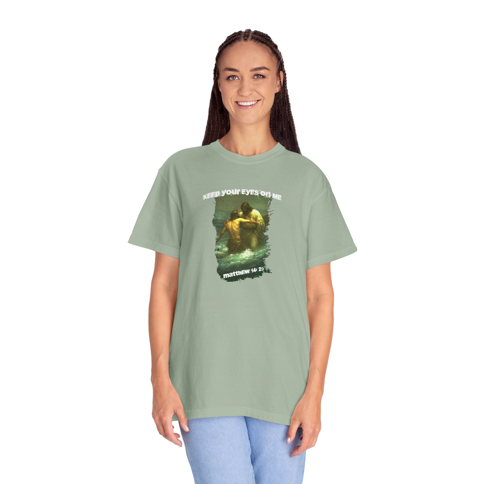 Person wearing a green t-shirt with a graphic design and text on a white background