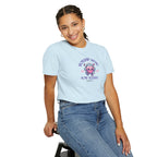 Person wearing a light blue t-shirt with a graphic design on a white background