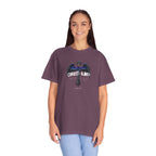 Person wearing a purple t-shirt with a graphic design on a white background