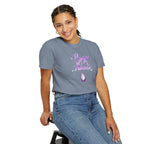 Person wearing a gray t-shirt with a graphic design on a white background