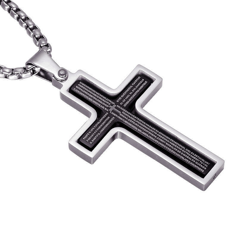 Silver cross pendant with engraved text on a white background