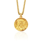 Gold necklace with a round pendant on a white background