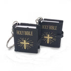 Two black keychains with 'HOLY BIBLE' text and gold crosses on a white background