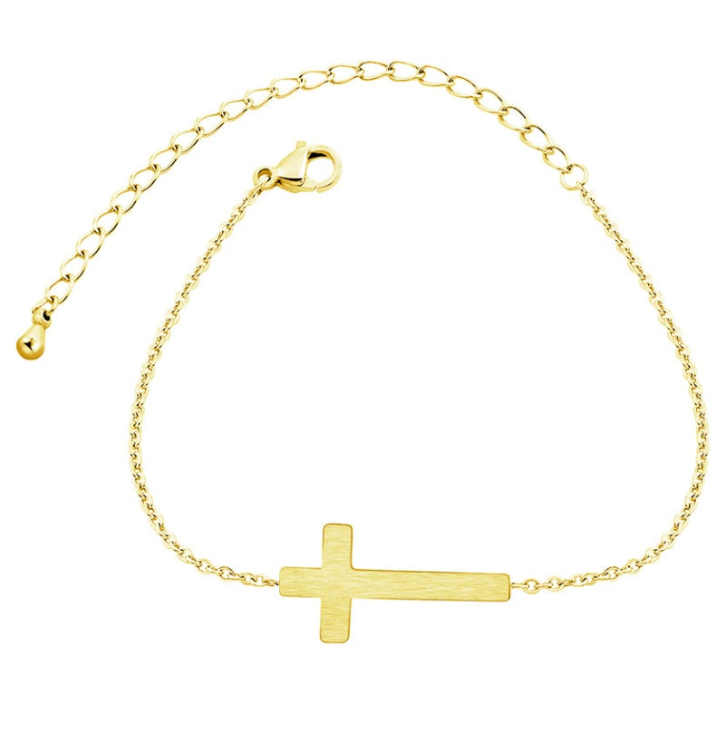 Gold bracelet with a cross charm on a white background