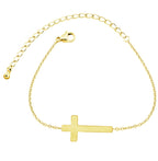 Gold bracelet with a cross charm on a white background